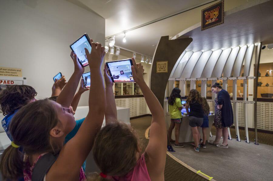 kids holding up tablets