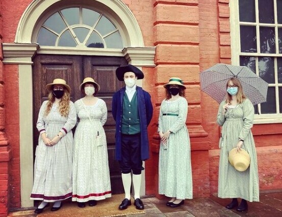 people dressed up outside building