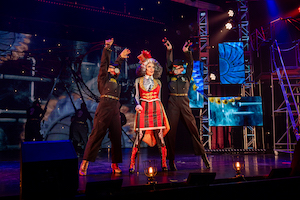 Freakshow host with two performers in Gas Masks